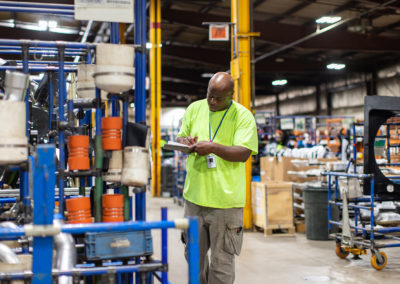 Warehouse worker looking at clipboard